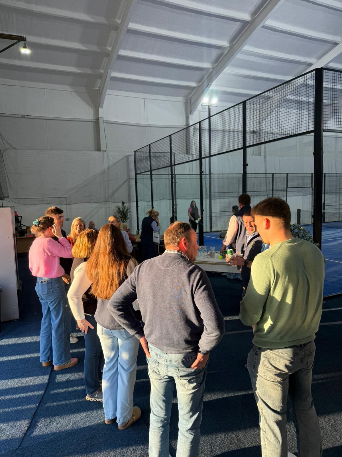 Players socialising beside the padel courts at Poplars Padel, East Cowick